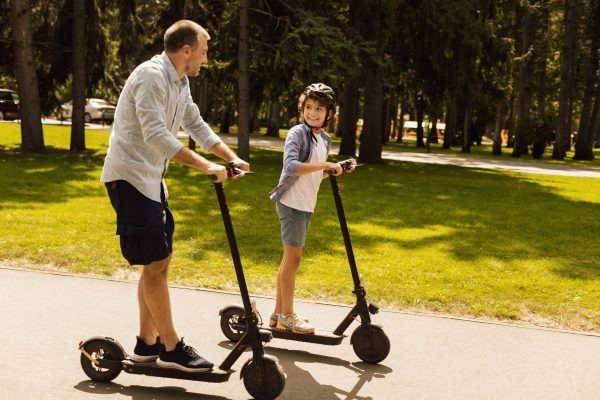 Father and son on electric scooters